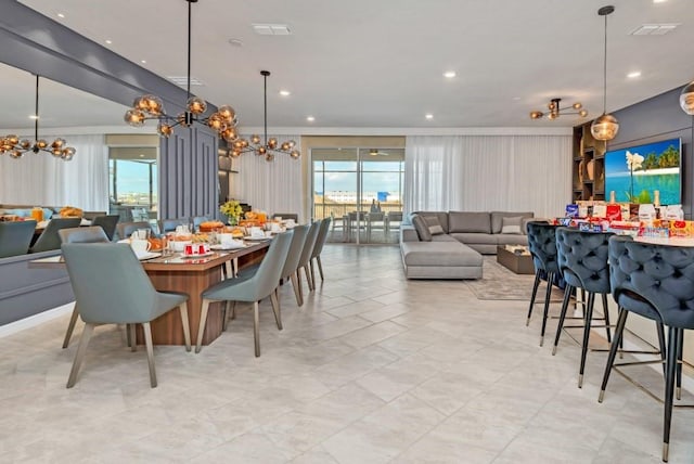 dining area with light tile floors, a healthy amount of sunlight, and a chandelier