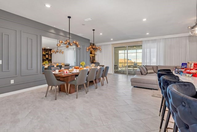 tiled dining area featuring an inviting chandelier