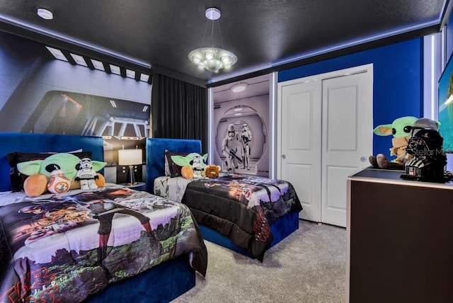 bedroom with carpet flooring, a notable chandelier, and a closet