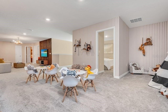 dining area with light carpet and a notable chandelier