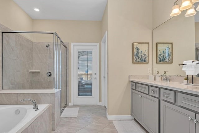 bathroom featuring oversized vanity, plus walk in shower, and tile flooring