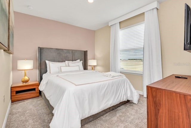 bedroom featuring light carpet