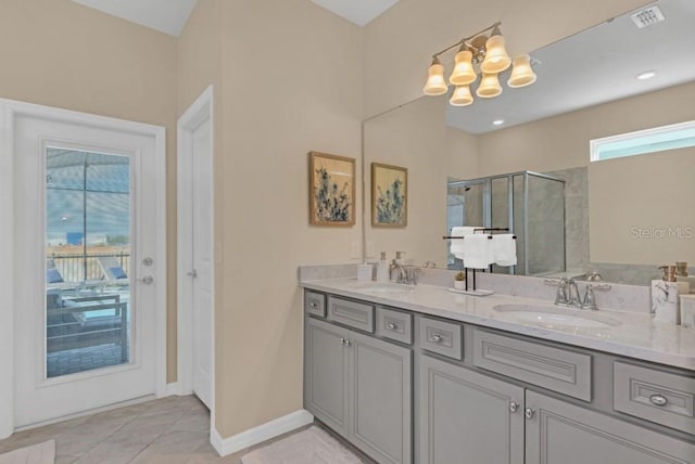 bathroom featuring large vanity, a notable chandelier, dual sinks, tile flooring, and an enclosed shower