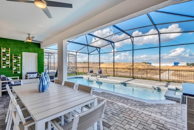 view of swimming pool featuring a patio, ceiling fan, and a lanai