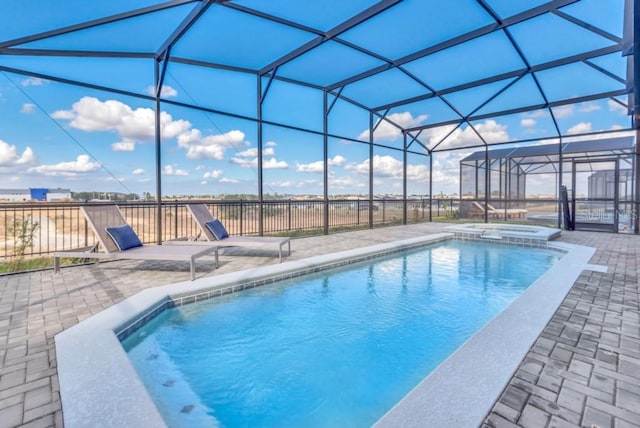 view of swimming pool with a patio area and glass enclosure