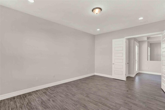 unfurnished room featuring dark hardwood / wood-style flooring