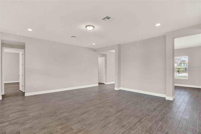 unfurnished room with dark hardwood / wood-style flooring