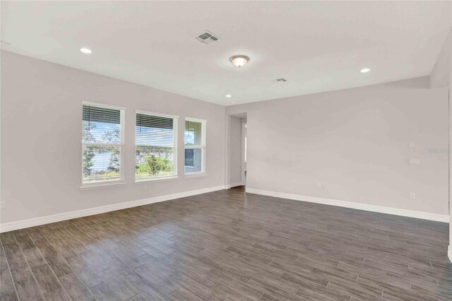 empty room featuring dark hardwood / wood-style flooring