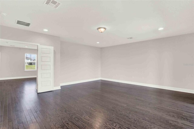 spare room featuring dark hardwood / wood-style floors