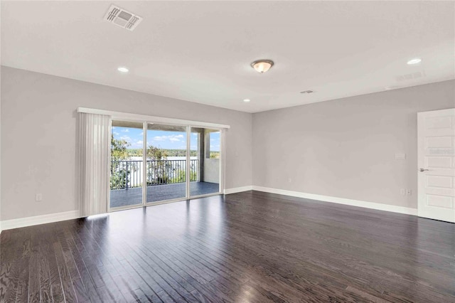 empty room with dark hardwood / wood-style flooring