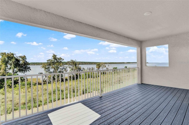 wooden deck featuring a water view