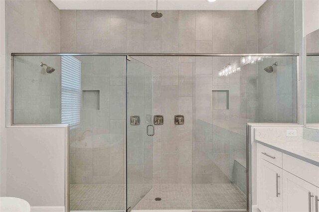 bathroom with vanity and walk in shower