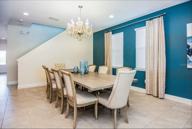 tiled dining area with an inviting chandelier