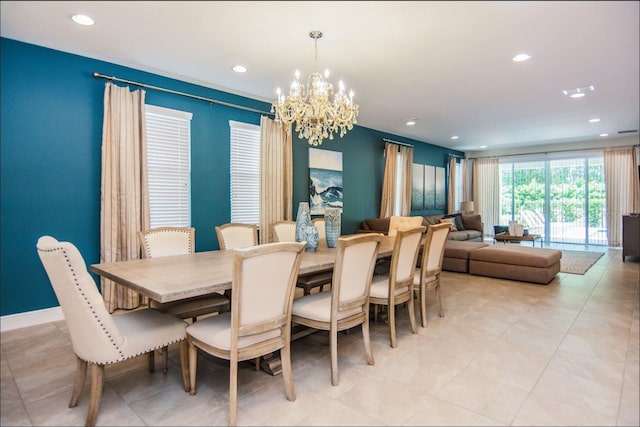 tiled dining room featuring a chandelier