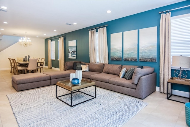 living room with light tile flooring and a notable chandelier