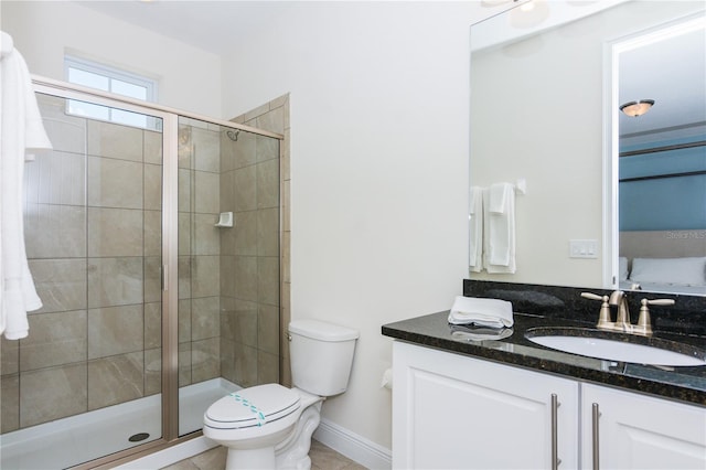 bathroom with vanity, tile floors, toilet, and walk in shower