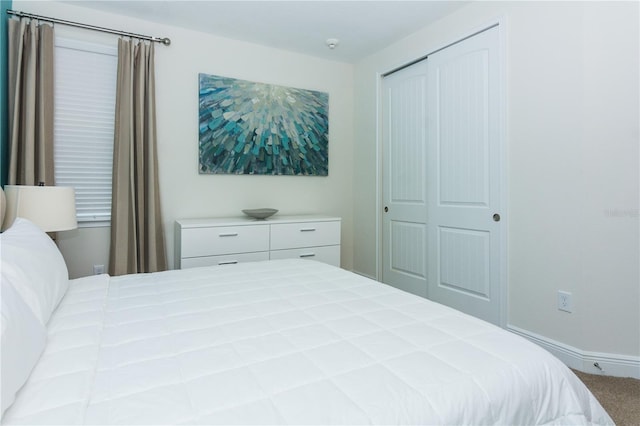 carpeted bedroom with a closet