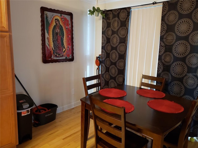 dining room featuring crown molding and light hardwood / wood-style floors