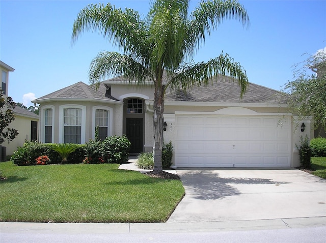 view of front of property with a front lawn and a garage