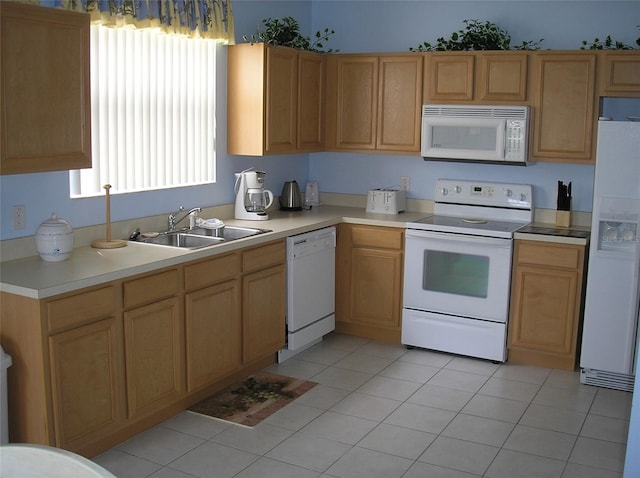 kitchen with light tile floors, white appliances, and sink