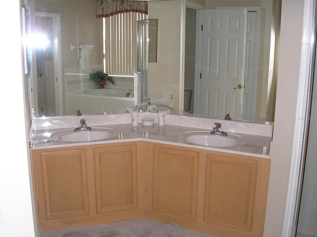 bathroom featuring double sink vanity and a tub