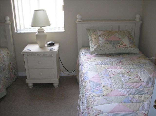 bedroom featuring dark colored carpet