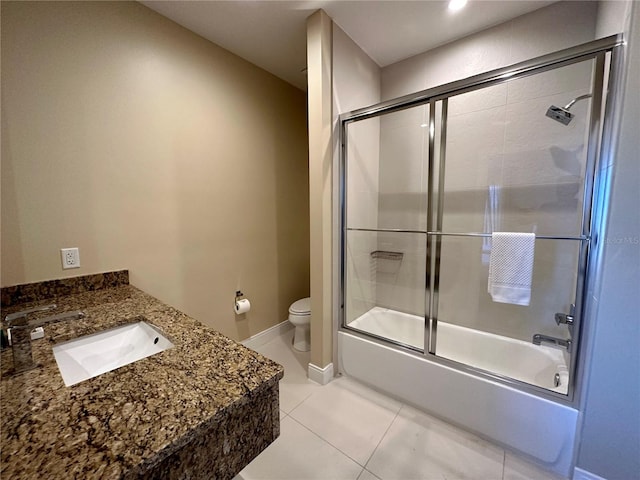 full bathroom featuring tile patterned floors, vanity, toilet, and bath / shower combo with glass door