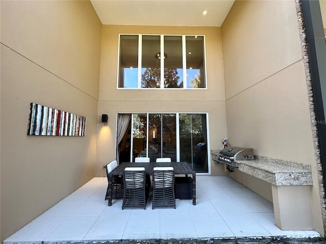 view of patio with area for grilling and exterior kitchen