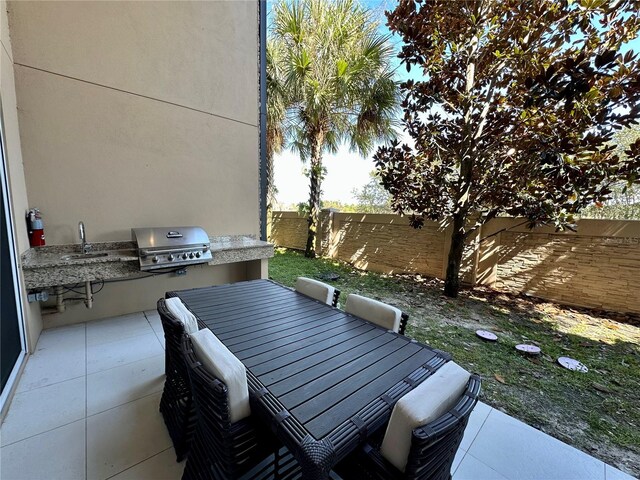 view of patio with area for grilling and sink