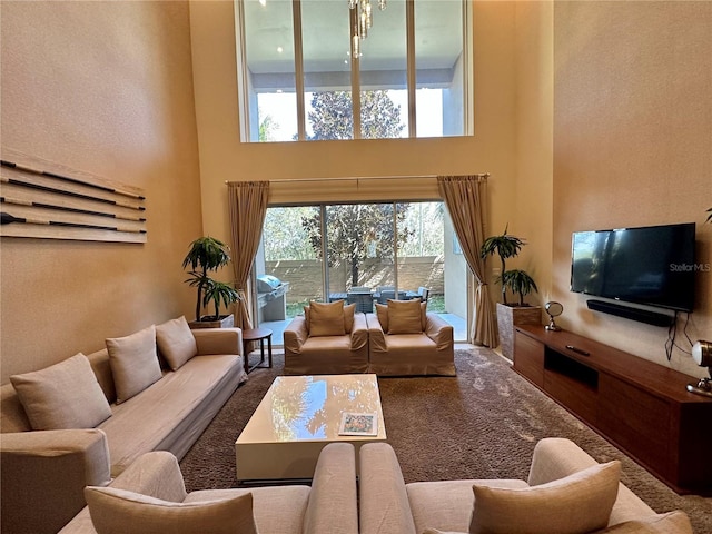 carpeted living room featuring a towering ceiling