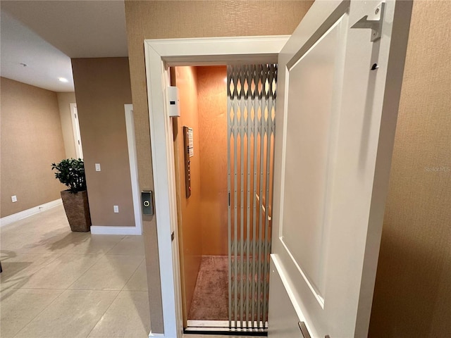 corridor with light tile patterned flooring