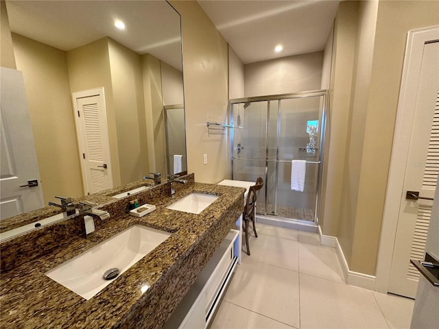 bathroom with vanity, tile patterned floors, and a shower with door