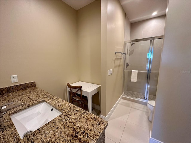 bathroom with toilet, vanity, tile patterned floors, and a shower with shower door