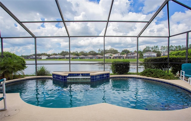 outdoor pool with glass enclosure, a patio, an in ground hot tub, a water view, and a residential view