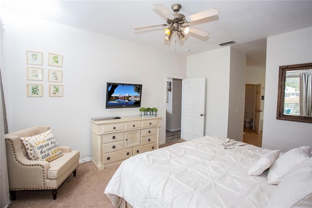 bedroom with a ceiling fan, visible vents, and light carpet