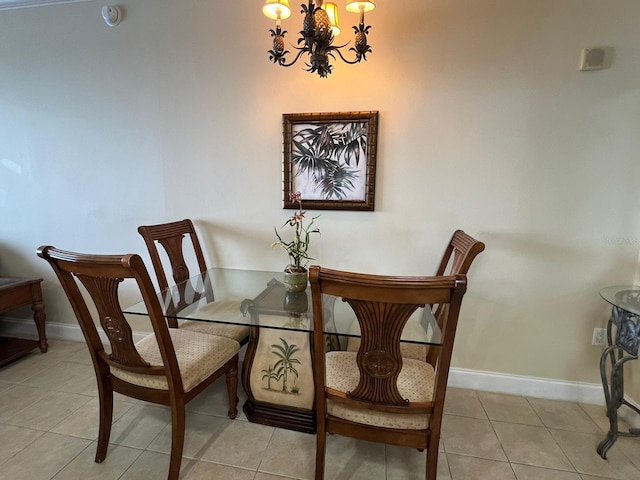 dining room with light tile patterned floors and a chandelier