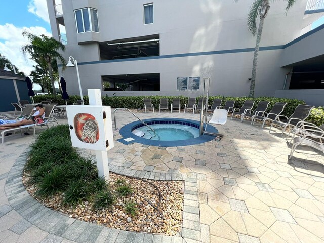 view of pool featuring a patio area and a hot tub