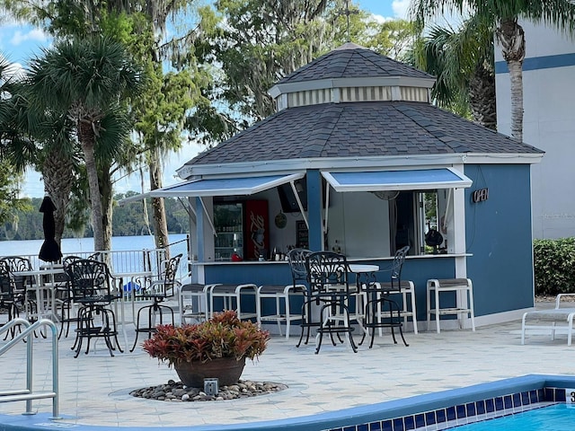 rear view of house featuring a bar