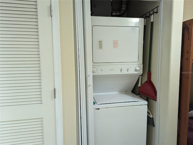 washroom featuring stacked washer and dryer