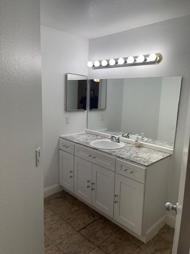 bathroom featuring tile flooring and large vanity