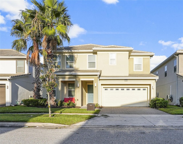 view of front of house with a front lawn and a garage