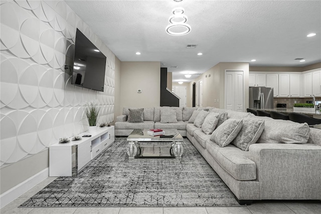 tiled living room with a textured ceiling