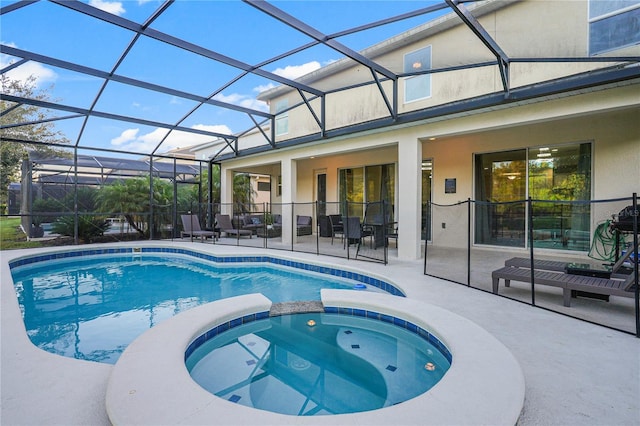 view of swimming pool with a patio area, an in ground hot tub, and a lanai