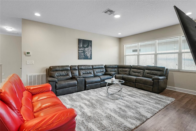 living room featuring a textured ceiling and dark wood-type flooring