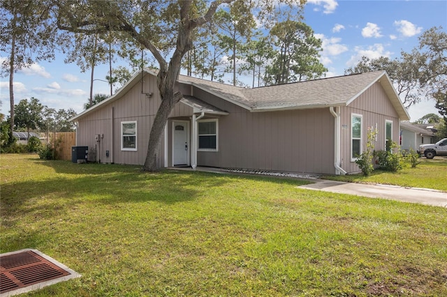 single story home featuring central AC and a front lawn