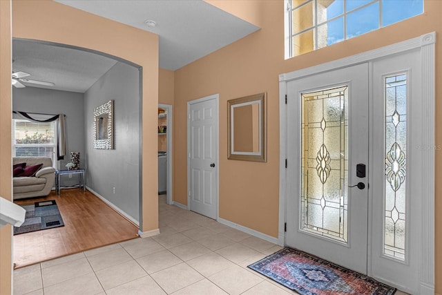 tiled foyer featuring ceiling fan