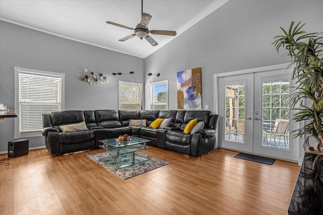 living room featuring french doors, ceiling fan, and light hardwood / wood-style flooring