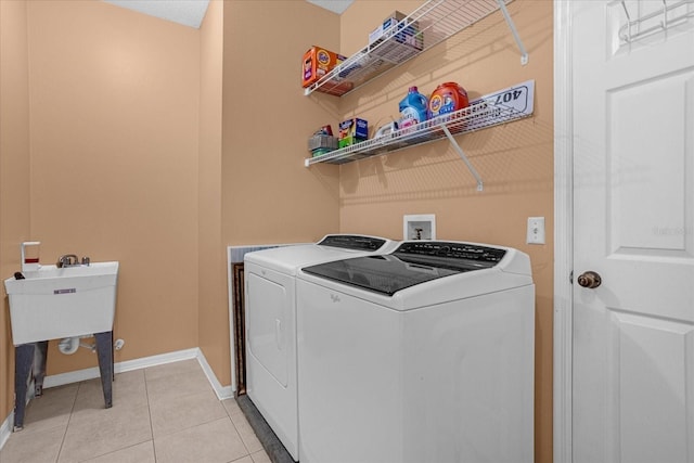 laundry area featuring hookup for a washing machine, washing machine and dryer, and light tile floors