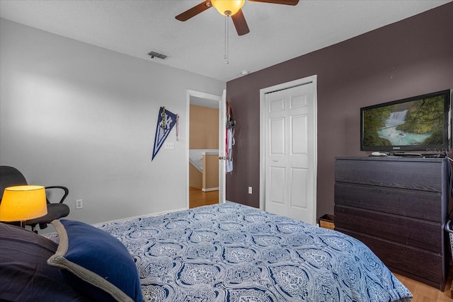 bedroom with a closet, ceiling fan, and light wood-type flooring