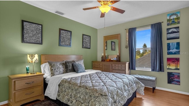 bedroom with ceiling fan and hardwood / wood-style flooring